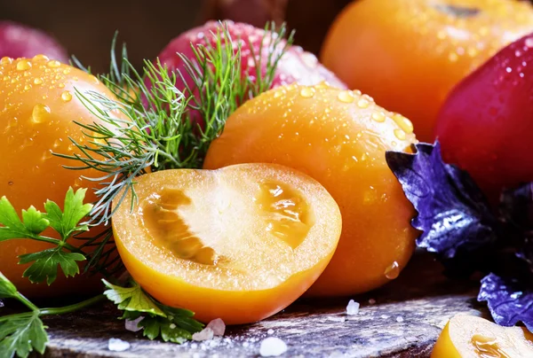 Orange tomatoes on a dark background — Stock Photo, Image