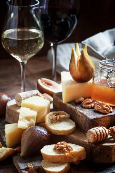 White and red wine, cheese, figs, nuts, honey and bread