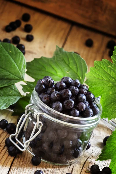 Fresh chokeberries in jar — Stock Photo, Image