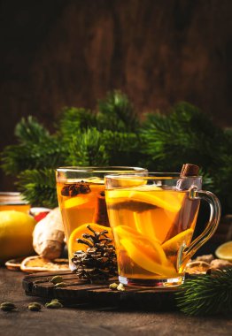 Zencefil, bal ve limonla siyah kış çayını iyileştiriyorum. Bağışıklık güçlendirici, cam bardakta, kırsal ahşap masa zemininde fotokopi alanı olan bir içecek.