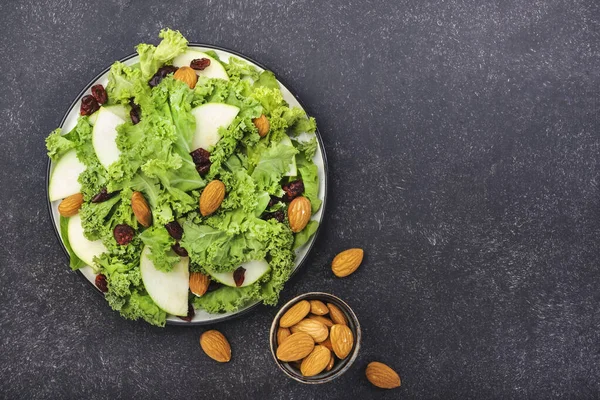 Vegan Kale salad with dried cranberry, apples and almonds. Healthy food, top view, black kitchen table — Stock Image Vegan Kale Salad Dried Cranberry Apples Almonds Healthy Food Top Royalty Free Stock Images