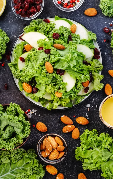 Vegan Kale salad with dried cranberry, apples and almonds. Healthy food, top view, black kitchen table — Stock Image Vegan Kale Salad Dried Cranberry Apples Almonds Healthy Food Top Stock Image