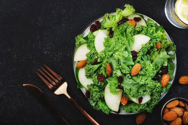 Vegan Kale salad with dried cranberry, apples and almonds. Healthy food, top view, black kitchen table — Stock Image Vegan Kale Salad Dried Cranberry Apples Almonds Healthy Food Top Royalty Free Stock Images