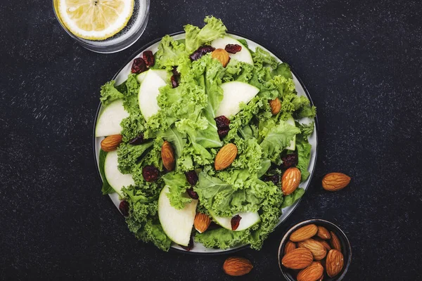 Vegan Kale salad with dried cranberry, apples and almonds. Healthy food, top view, black kitchen table — Stock Image Vegan Kale Salad Dried Cranberry Apples Almonds Healthy Food Top Stock Photo