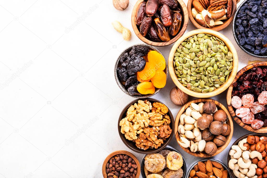 Nuts and dried fruits. Dried apricots, figs, raisins, pecans, walnuts, hazelnuts, almonds and other. White background, top view