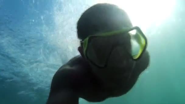 Man swimming underwater. Diving on the Black Sea. Man plunges into the sea.  Go-Pro video.  Diving, man dives and swims under water.  Marine dive, active, bright impressions. Go-Pro video. — Stock Video