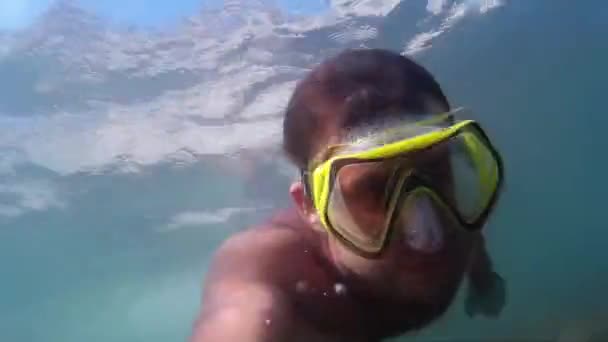 Man swimming underwater. Diving on the Black Sea. Man plunges into the sea.  Go-Pro video.  Diving, man dives and swims under water.  Marine dive, active, bright impressions. Go-Pro video. — Stock Video