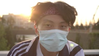 Tıbbi koruyucu maskeli genç bir Asyalı 'nın portresi.