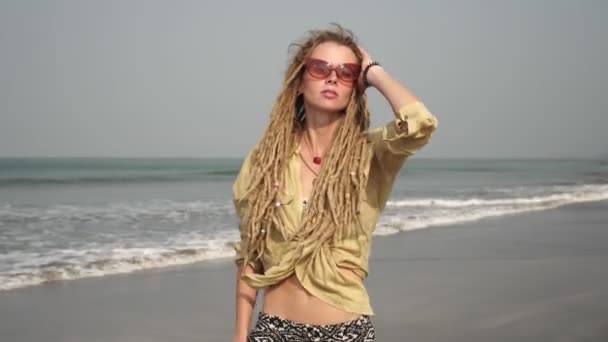 Young modern hippie woman in hair dreadlocks outdoors on the background of sea — Stockvideo