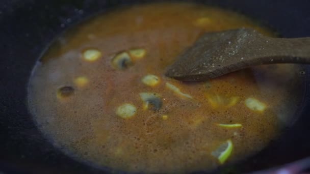 Hot Thai or Asian tom yum soup is cooked in a saucepan — Wideo stockowe