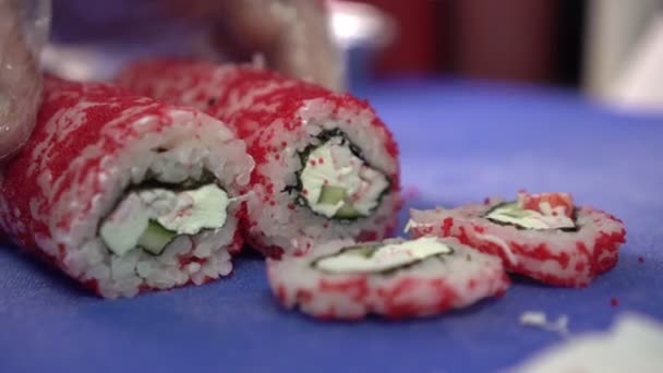 Chef cuts a beautiful Japanese sushi with a knife, close-up — Stock Video