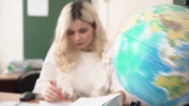 Globe ve okul öğretmeni, coğrafya dersi konsepti. Üniversite dersi, masada öğretmen.