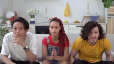 Bir grup futbol ya da spor taraftarı evde televizyon izleyip zafere seviniyorlar.