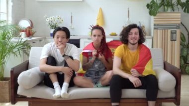 İspanyol futbol taraftarları evde TV izler. İspanya bayrağı taşıyan bir spor taraftarı topluluğu.