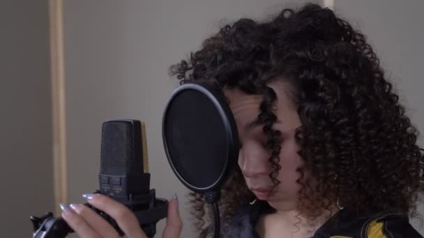 Une chanteuse fatiguée dans un studio d'enregistrement. Portrait d'une jolie chanteuse avec un microphone lors de l'enregistrement d'une chanson — Video