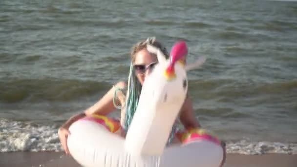 Cheerful funny happy woman dancing in an inflatable swimming ring on the sea beach — Stock Video
