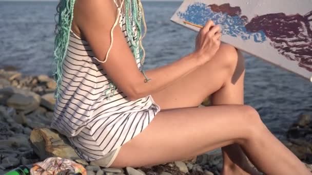 Mulher artista pinta o mar em tela. Pintura, artista contemporâneo pinta um quadro na natureza — Vídeo de Stock
