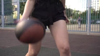 Sokakta basketbol oynayan bir kadın, yakın plan.