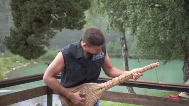 L'homme joue du balai comme une guitare. Un guitariste masculin tient un balai comme une guitare et montre qu'il joue de la musique — Video