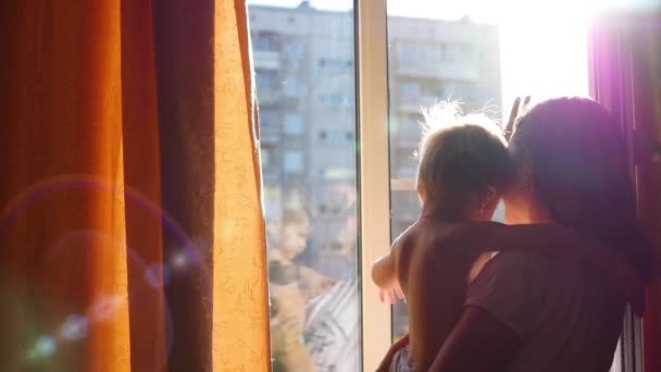 La chica con el niño abrazándose suavemente al sol — Vídeo de stock