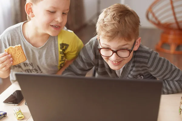 Happy boy sitting With laptop computer