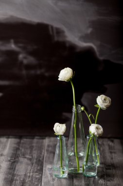 White buttercups in the bottles