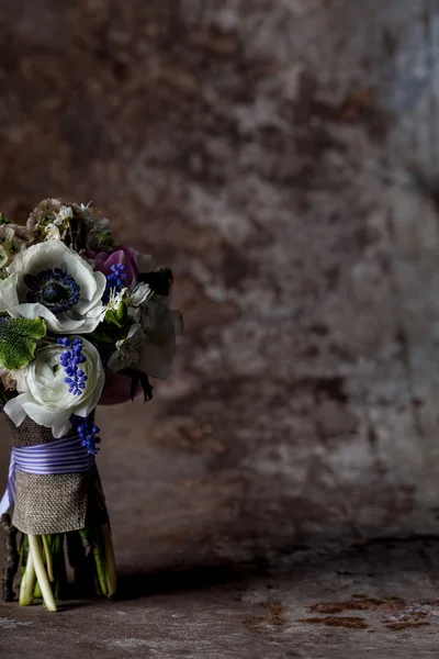 Pastel flower arrangement on rust