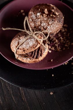 Organic cookies with pieces of chocolate on the plate and old wo