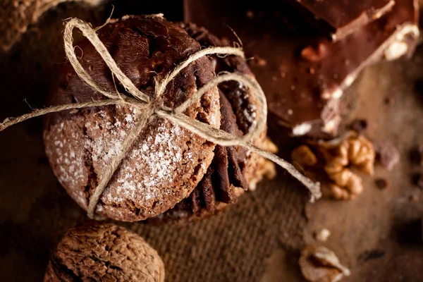 Maroni cookies with pieces of chocolate and walnuts on old woode