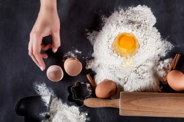 Baker is making  cookies with wooden rolling pin
