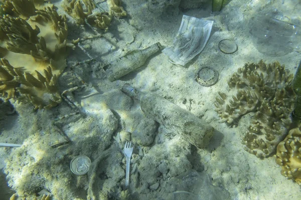 Face masks and plastic debris on bottom in Red Sea. Coronavirus COVID-19 is contributing to pollution, as discarded used masks clutter polluting seabed along with plastic trash