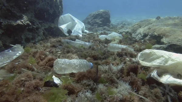 Massive plastic pollution of the ocean bottom. Seabed covered with a lot of plastic garbage. Bottles, bags and other plastic debris on seabed in Mediterranean Sea. Plastic pollution of the Ocean