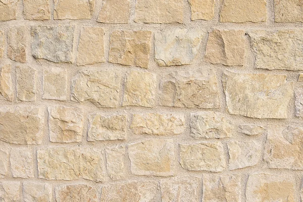 Old beige stone wall background texture — Stock Photo, Image