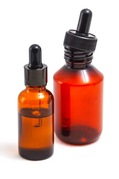 Bir pipet ile turuncu cam şişeler.