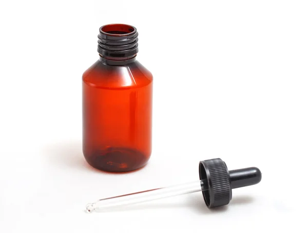 Bir pipet ile turuncu cam şişe.