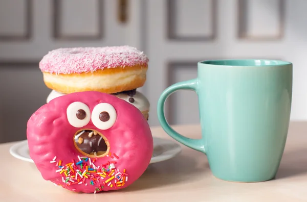 Tea with sweet bright donuts