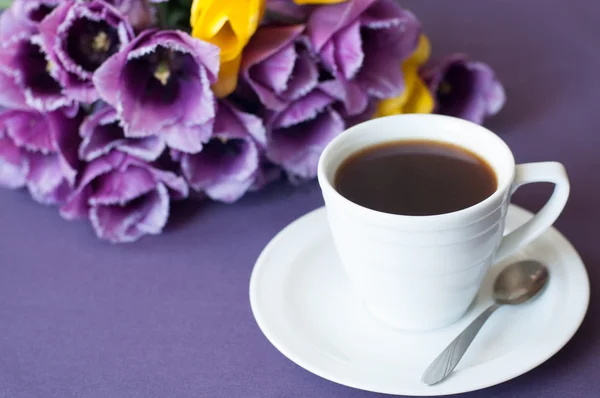 Xícara de café e um buquê de tulipas — Fotografia de Stock