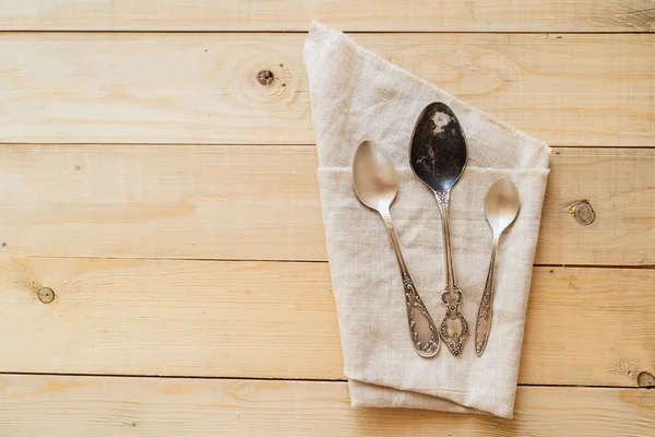 Top view wooden table setting with copyspace, three antique spoons — Stock Photo, Image