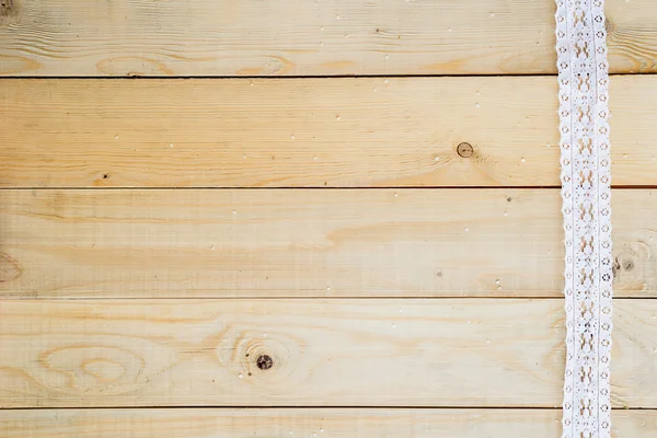 Hantverk-konceptet, Spetsband på trä bakgrund — Stockfoto