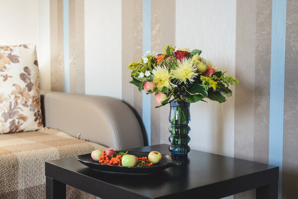 Autumn composition of bouquet and apples with rowan