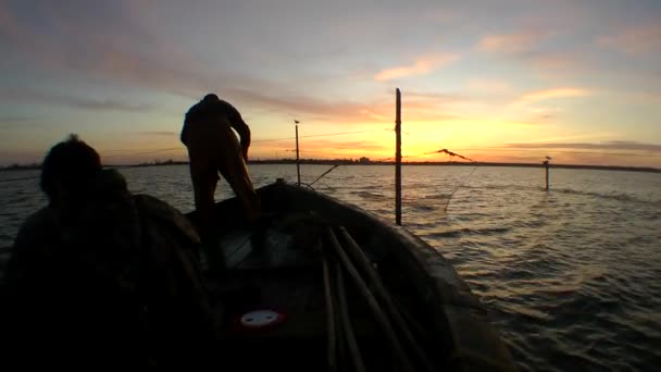 Vissersboot bij zonsopgang in de vaste netten. — Stockvideo