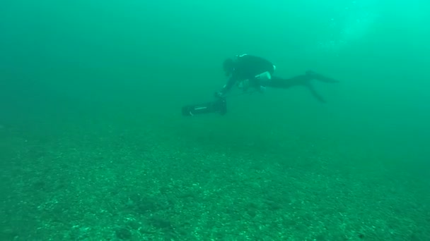 O mergulhador está se movendo em uma scooter subaquática . — Vídeo de Stock