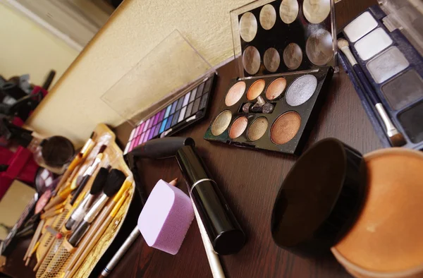 Diferentes ferramentas de maquiagem em uma mesa pronta para usar closeup — Fotografia de Stock