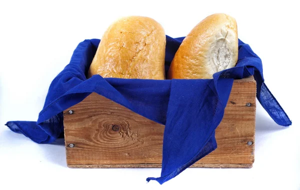 Loafs of bread in a old fashion busket closeup isolated — Stock Photo, Image