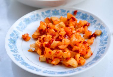 Tabakta kırmızı biberli Çin turpu..