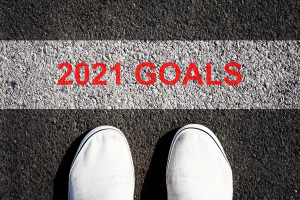 2021, Goals. Sneakers in front of the white line. Concept of plans and goals for the next year. View from above.