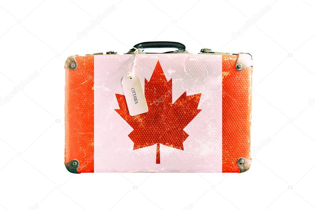 Old suitcase with the flag of Canada. Isolated on a white background