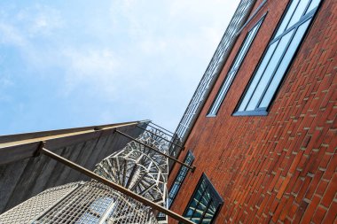 Malmö. İsveç. 29 Temmuz 2019 Metal spiral merdiven bir tuğla binanın ön cephesinde. Şehir modern mimarisi. Alt manzara. Ayrıntılar.