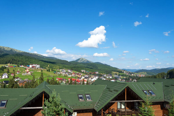 Nice view of cottages and hotels at the foot of the mountain. Ukraine. Bukovel. Carpathians. Summer rest. Tourism. Travels.