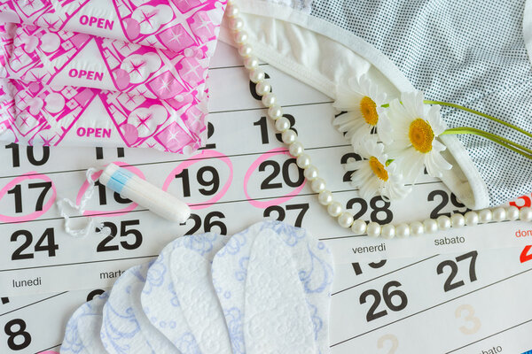 Sanitary pads , calendar , tampons , underwear with white daisies